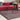 Pink velvet sofa with pink faded rug and metal and glass coffee table
