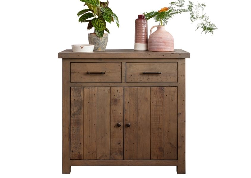 Cut out of medium reclaimed wood sideboard with plants and ornaments on top
