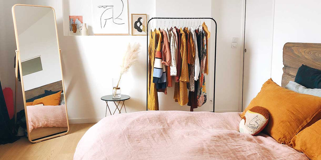 Floor Mirror in Bedroom with Bed and Open Wardrobe