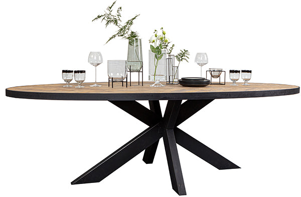 An oval shaped industrial dining table made of oak